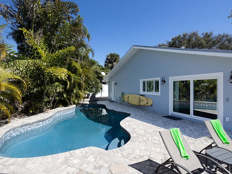 Primary Bed Room slider leads out to pool deck
