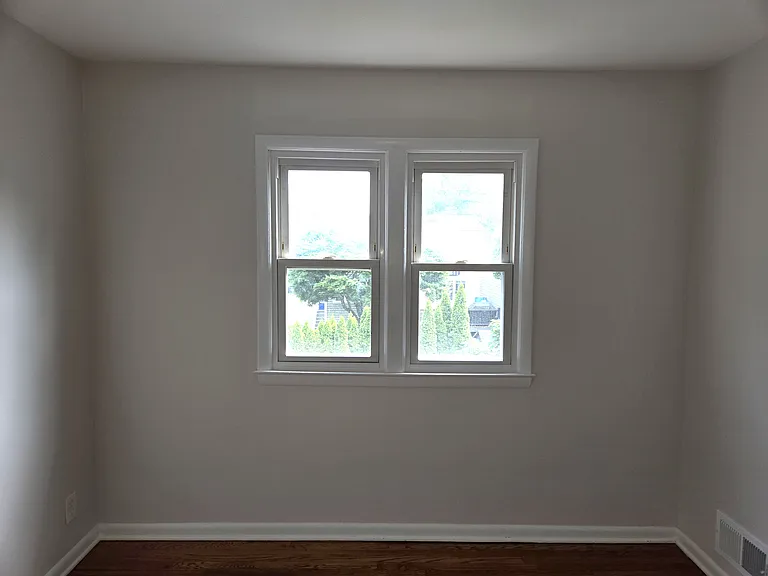 1st Bedroom with hardwood floors and closet.