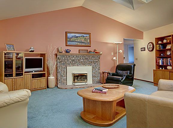 Wow! Vaulted ceilings with skylights! Masonry fireplace has a gas bay style insert. Just off the kit