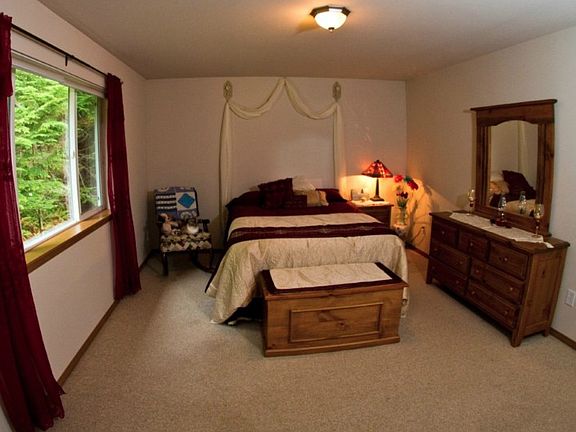 The master suite is spacious and looks out to the peaceful green belt in back.