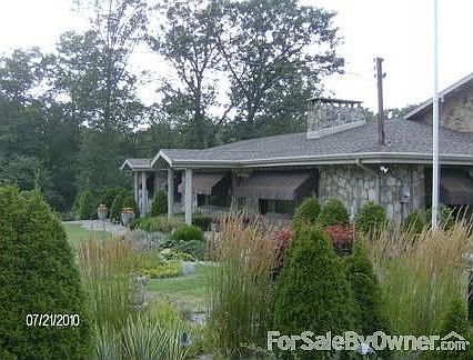 Front of the home from East Pike
						:
						Elegant stone ranch professional landscaping