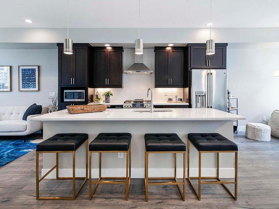 Large, open kitchen with island and stainless steel appliances