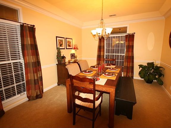 Formal dining room with trey ceiling, updated lighting & transom windows