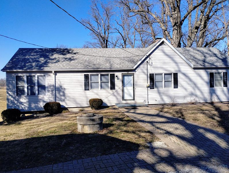 FRONTOF HOUSE WITH LARGE SIDEWALK.
