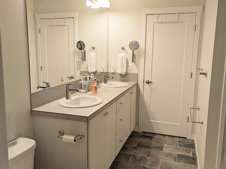 Primary bathroom with double sinks and large mirror.