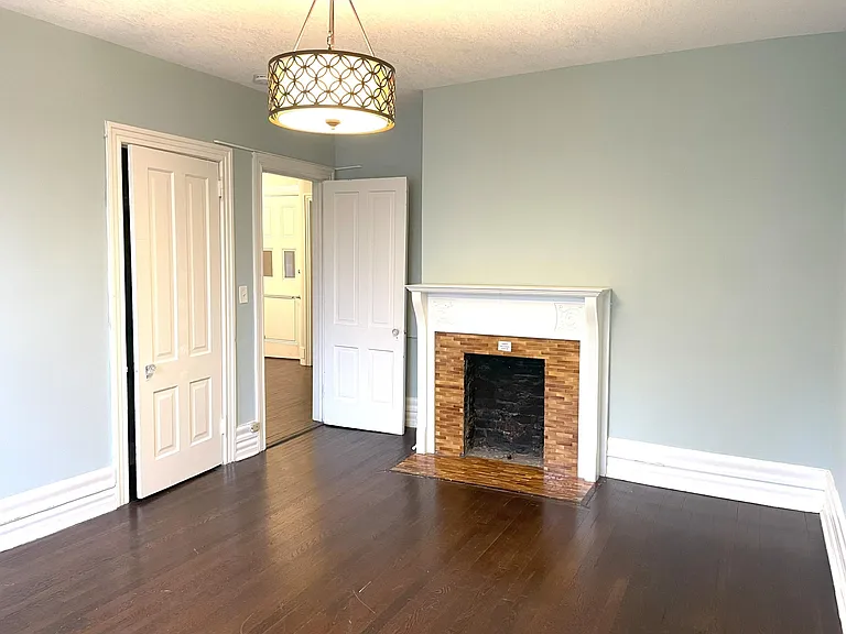 Large second bedroom with decorative vintage fireplace