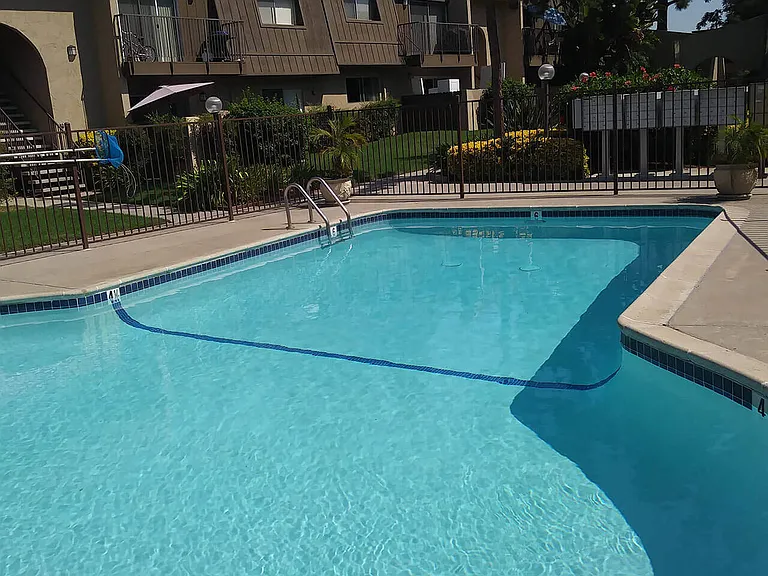 Large crystal clear swimming pool at Teton Pines Apartments in Escondido, California.
