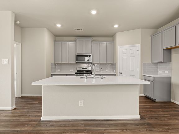 The kitchen has a large center island perfect for breakfast bar.