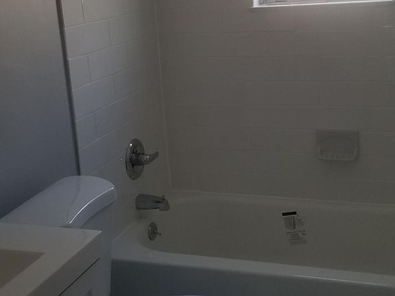 Recently renovated full bathroom, newer bath tub, toilet, vanity, ceramic tile.