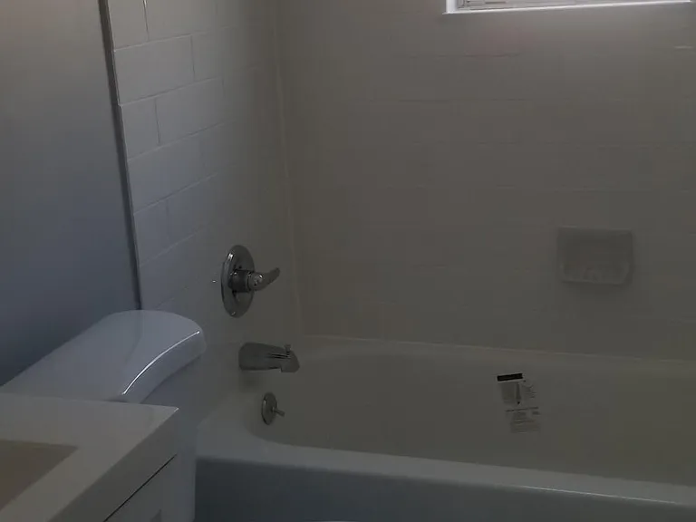 Recently renovated full bathroom, newer bath tub, toilet, vanity, ceramic tile.