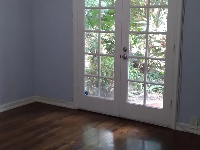 Secondary bedroom/office with doors out to backyard.