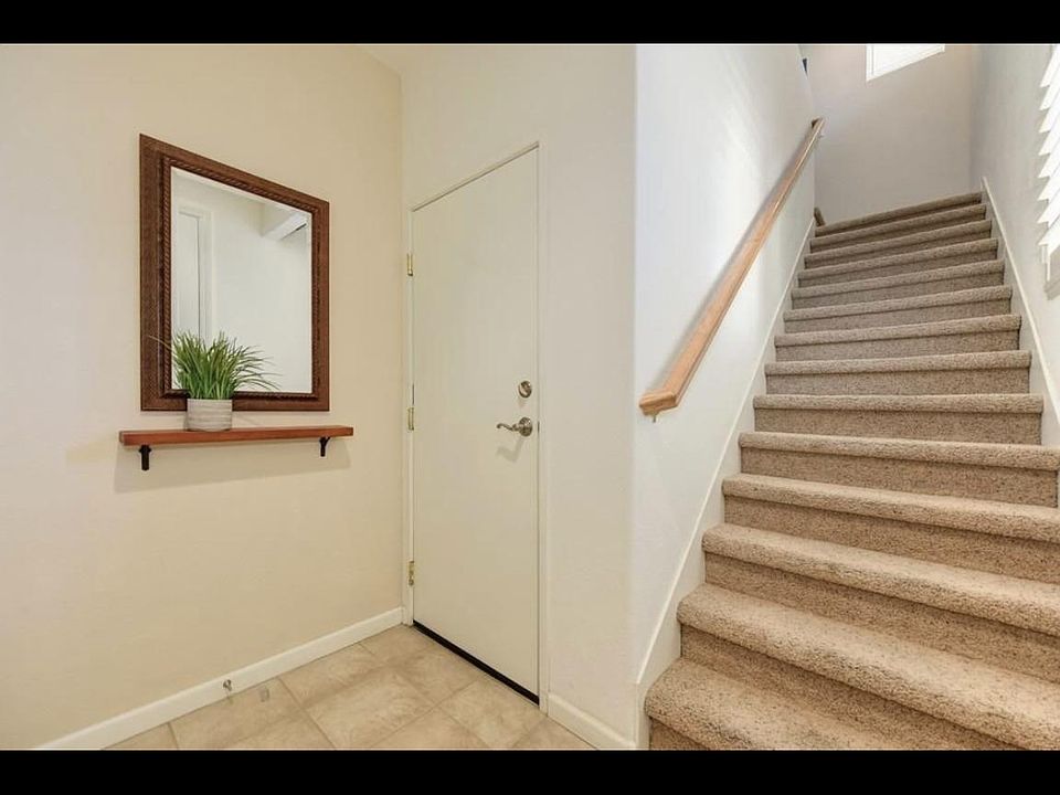 Entrance - Stairs to the upstairs living area and door to two car garage