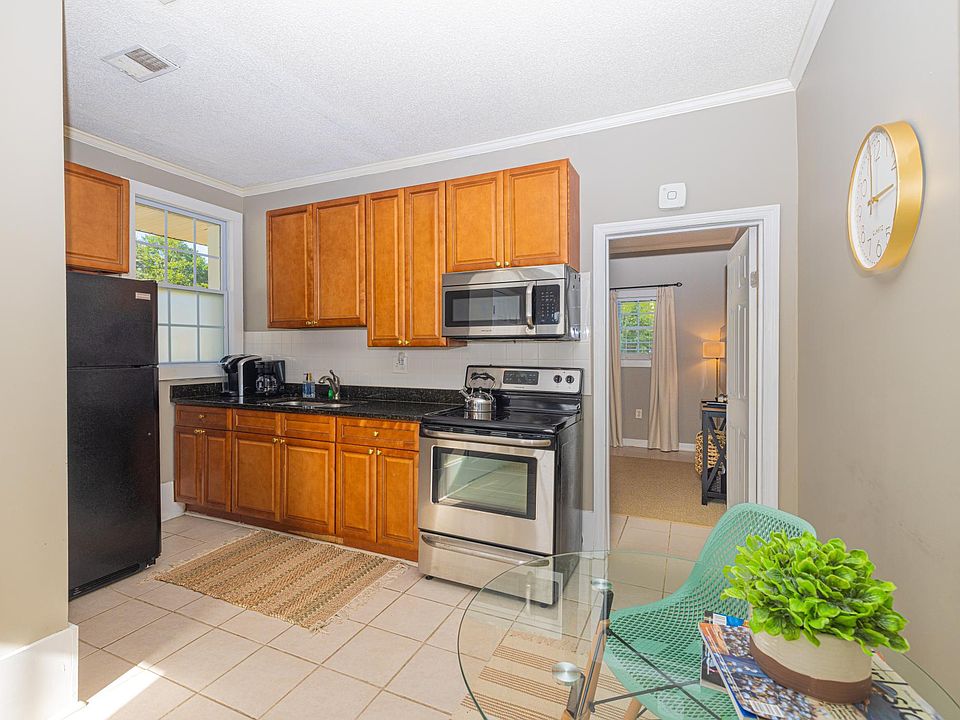 Kitchen has electric stove/oven, over-range microwave, full size refrigerator, toaster, drip coffee maker, and Keurig