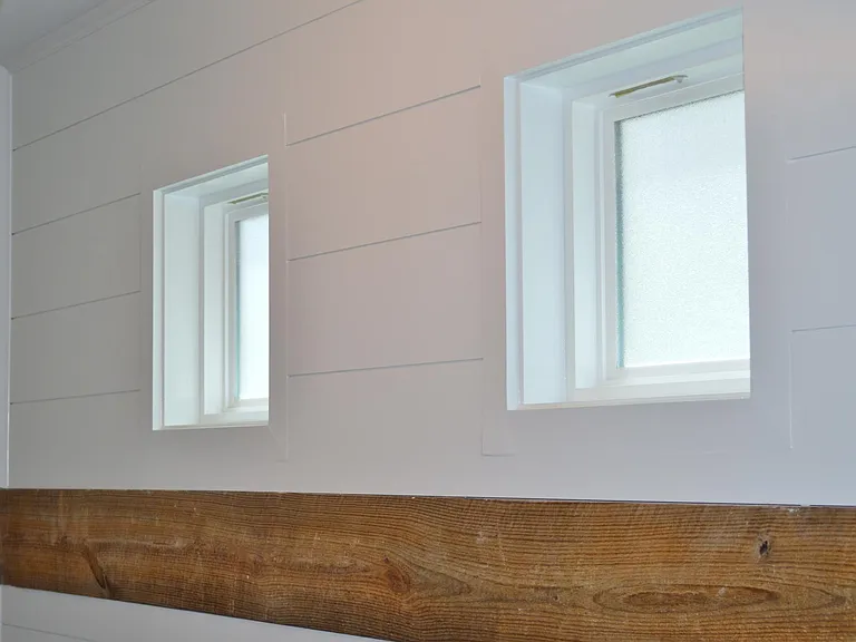 Two frosted windows maintain privacy while allowing sunlight to stream into the entryway.