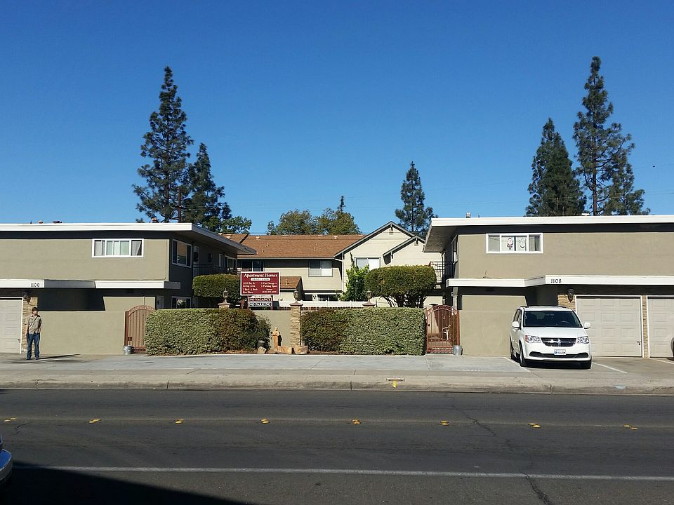 Street View of gated apartments with garage and off-street parking space.
