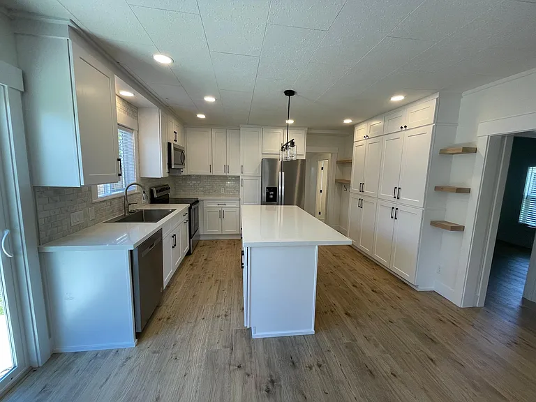View of kitchen in open concept living space from dining area