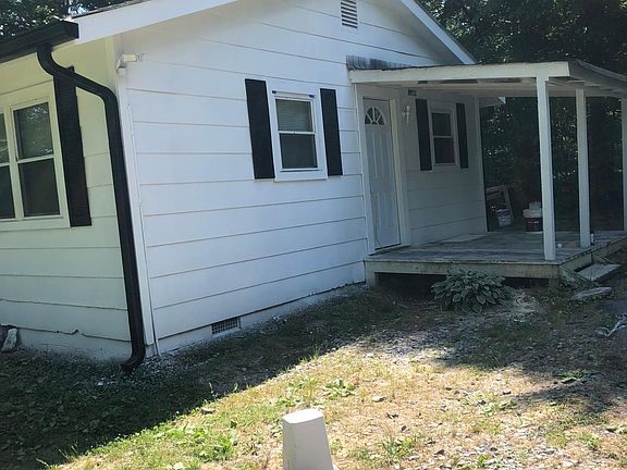 side of house with small covered deck right off of the kitchen