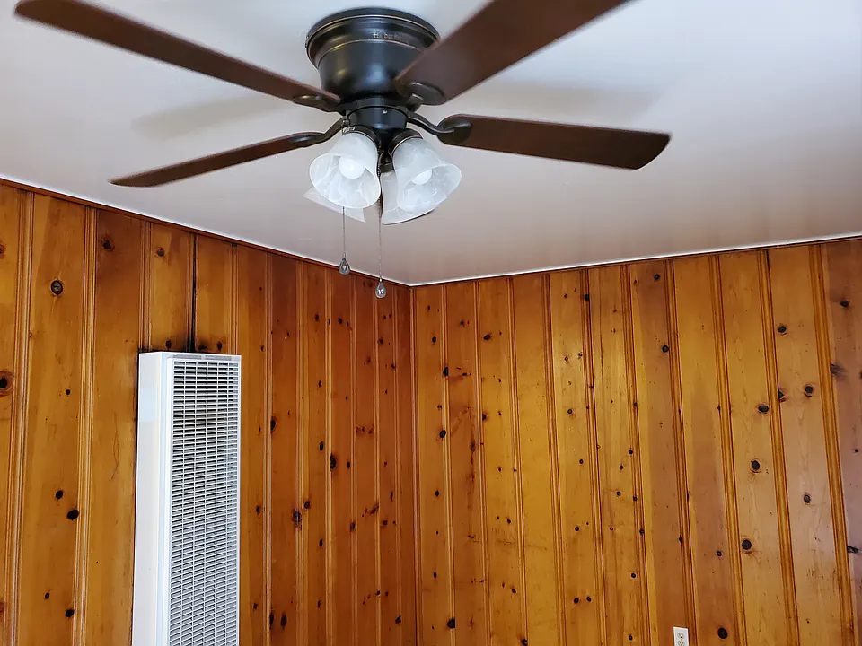 New Ceiling fan and wall furnace with thermostat controls.