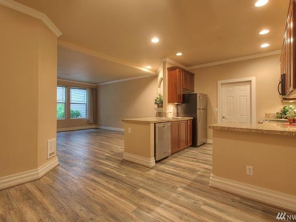 Spacious kitchen all stainless steel appliances stove is newer. Crown molding throughout! Door to garage.