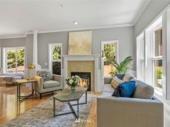 The living room features maple hardwood floors, chair rail molding, a new marble surround gas fireplace and flows into the adjacent spacious formal dining room (no steps).