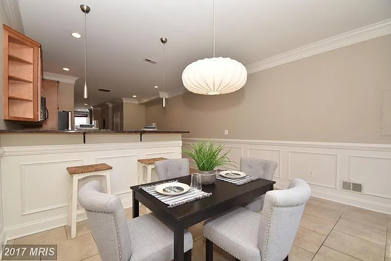 Dining area comes furnished with custom farm table & chairs (not pictured).