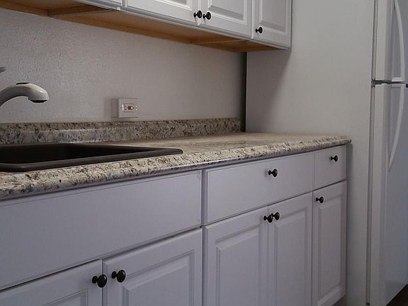 Kitchen with granite sink and refrigerator