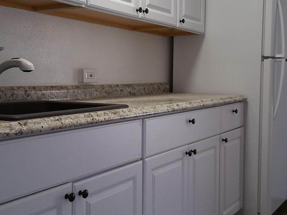 Kitchen with granite sink and refrigerator