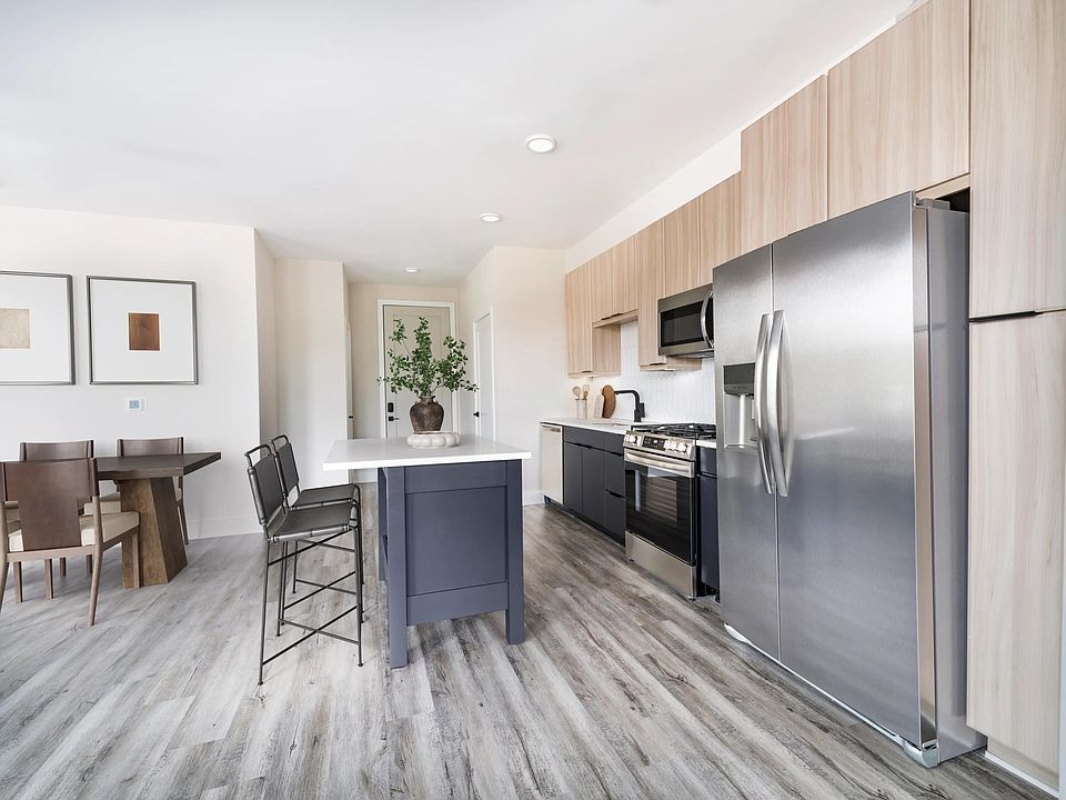 Sleek kitchens at Modera Westside Trail feature a spacious island and multiple contemporary finish options, creating a refined space for everyday living.