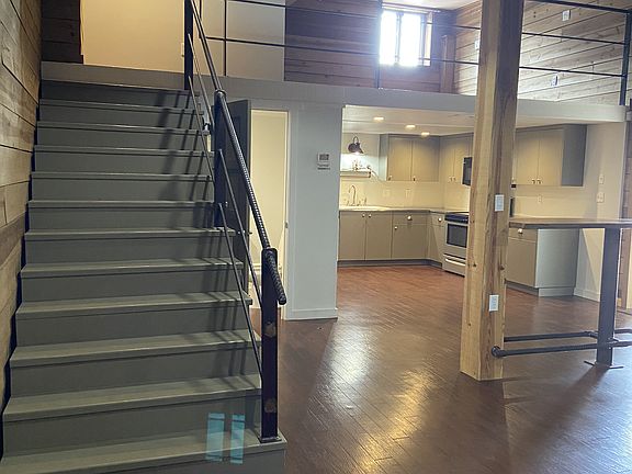 Staircase up to lofted bedroom and additional bathroom.