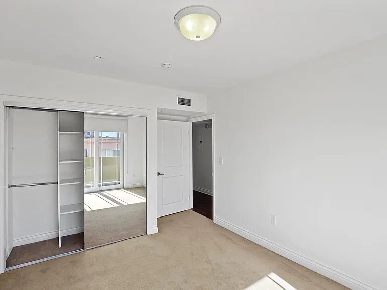 Bedroom with Mirrored Closet with Shelving