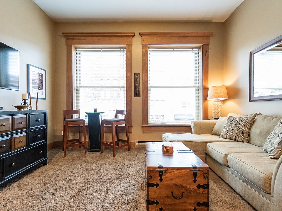 Bright and sunny living room overlooking Mass Ave. This unit comes FULLY FURNISHED!