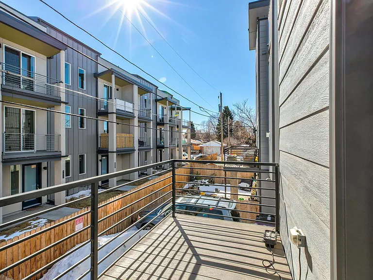 Balcony on main level, off of kitchen over private, fenced-in backyard