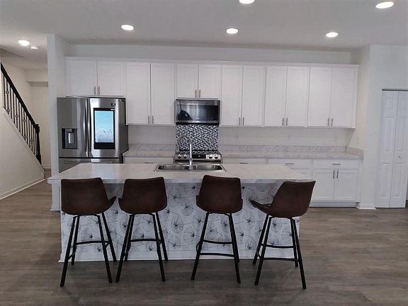 Kitchen with island and all appliances stay.