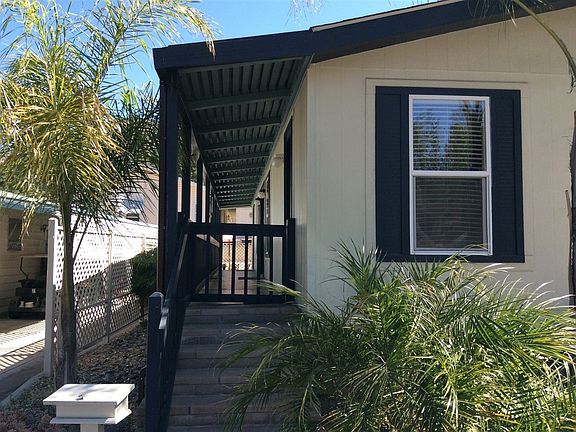 Beautiful fenced-in porch the length of the home with french doors leading from both bedrooms and li
