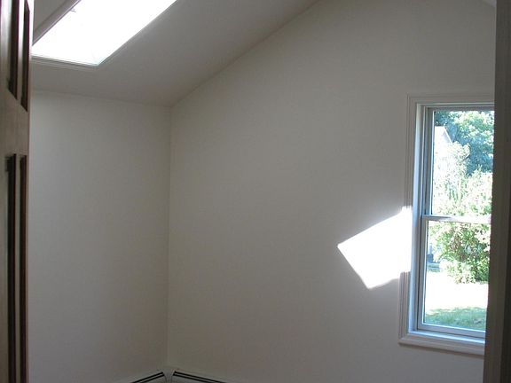 Bedroom w/cathedral ceiling and skylight