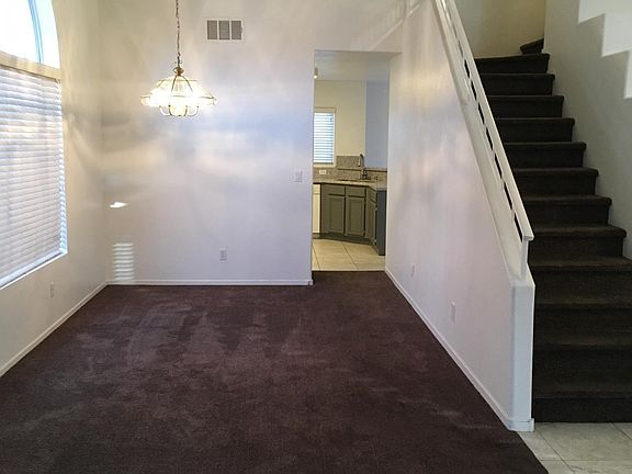 Living room and formal dining with many windows and open floor plan.