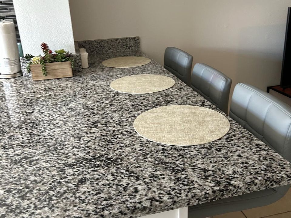 Breakfast bar with beautiful placemats and stylish decor for added comfort.