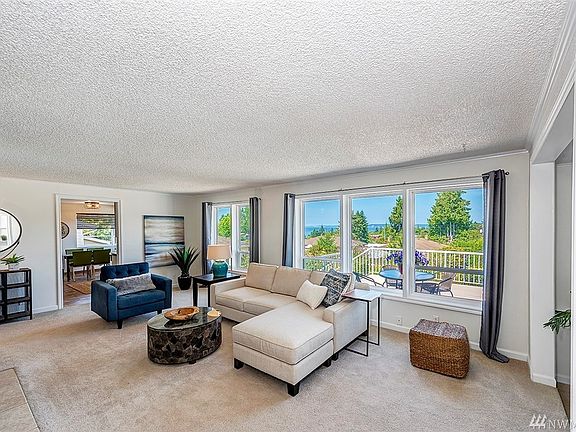 Wonderful living-room with gorgeous views of Puget Sound.  Hardwood flooring under carpet.