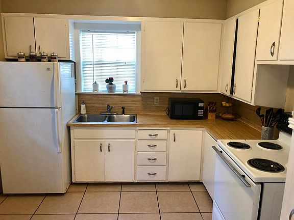 Cozy kitchen with fridge and stove