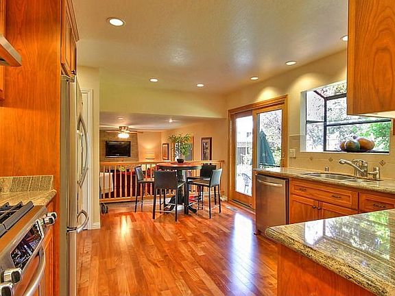 39931 San Simeon Court Kitchen with Hardwood Flooring and Granite Slab Countertops