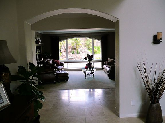 Entry Way Looks Straight Through Formal Living Room into Backyard Waterfall