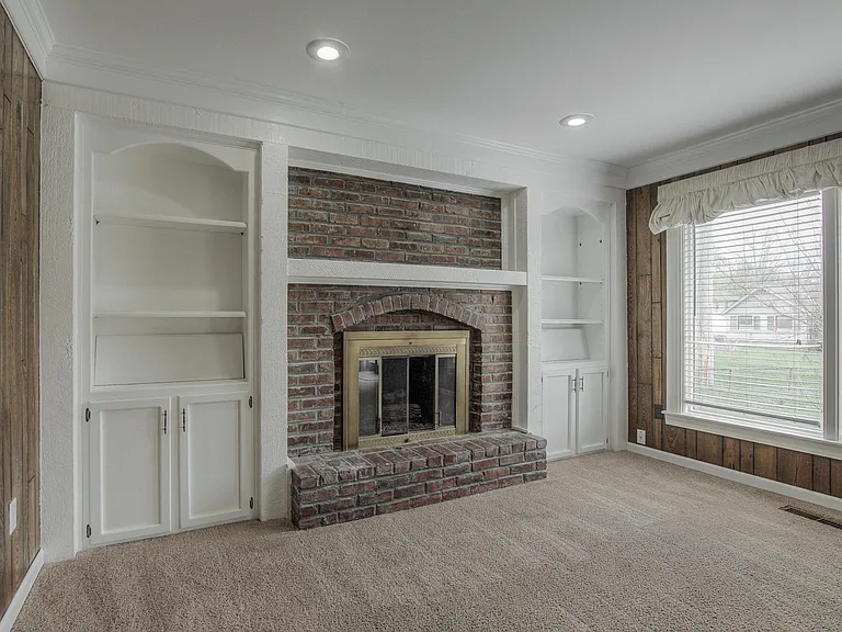 Family room with updated built-ins and plenty of space to relax. PANELING BEING REMOVED; Light gray walls to match new gray carpet being installed.
