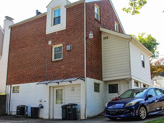 Back of home with driveway
