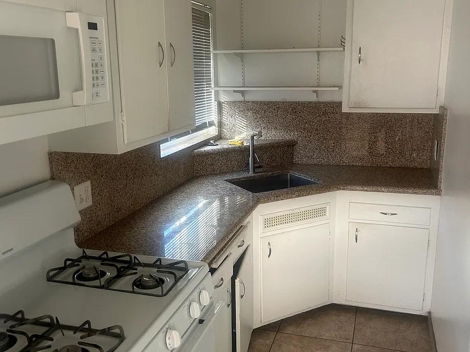 Kitchen with gas stove , fridge, mounted microwave Plenty of cabinets