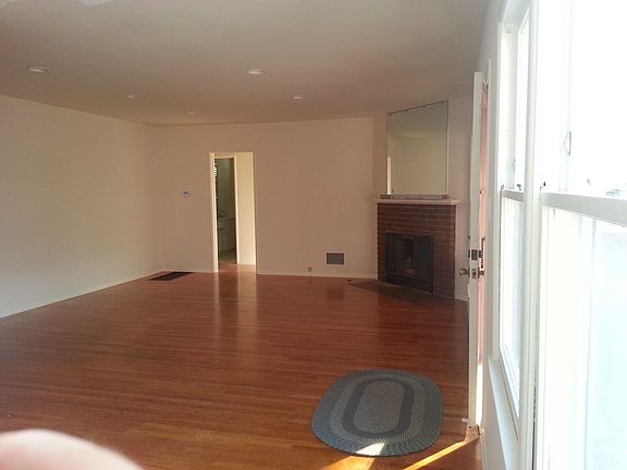 Dining and living rooms with fireplace and beautiful hardwoo