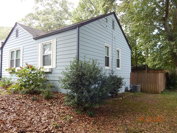 Side of house showing back fence