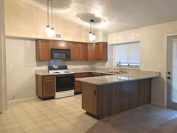 Open kitchen with room for large refrigerator.