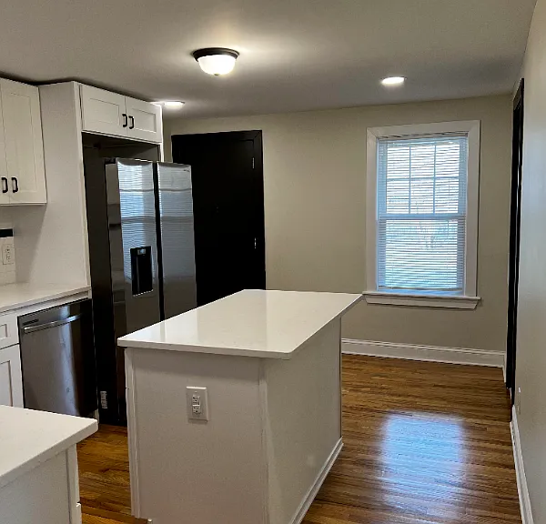 Beautiful kitchen with gas stove, mounted microwave, and dishwasher.