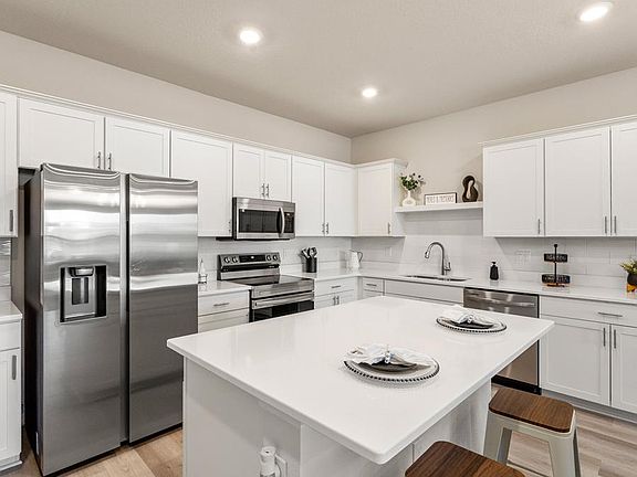 Your beautiful new open kitchen includes an island and stainless steel appliances - Flora townhome b
