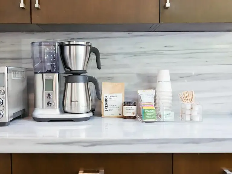 Delight in our selection of artisanal coffee and premium teas, accompanied by a top-of-the-line coffee maker, ensuring you have everything you need for the perfect cup every time.